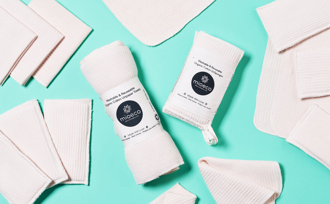 Stack of folded organic cotton reusable paper towels on a kitchen counter, ready to replace disposable rolls